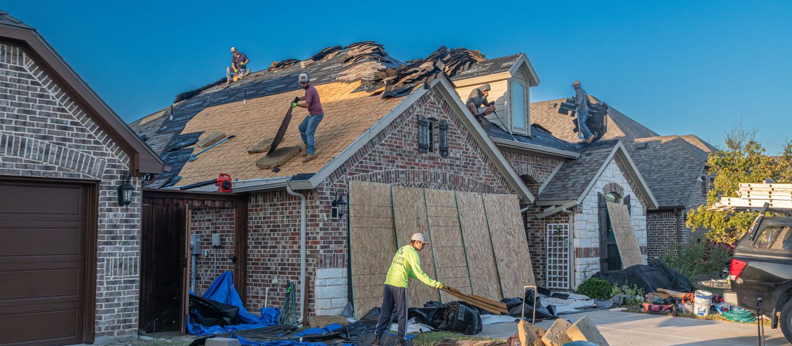 Roofing crew mid re-roof on a residential home